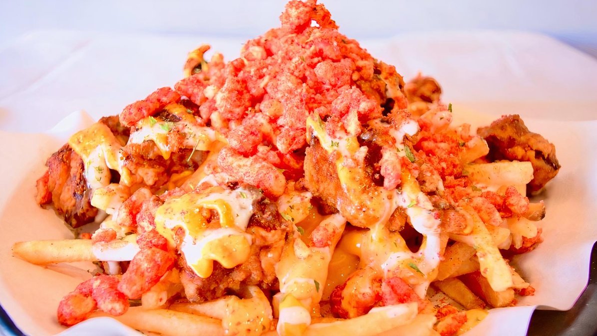 Sloppy Cheeto Fries with seasoned chicken, melted cheese and crushed Cheetos